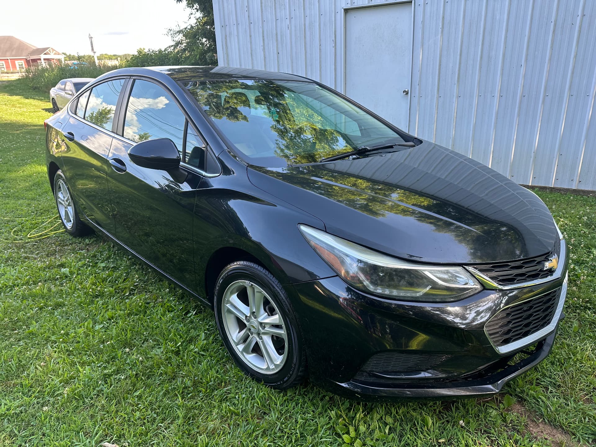 Black Chevrolet Cruze with mirror-finish paint after detailing