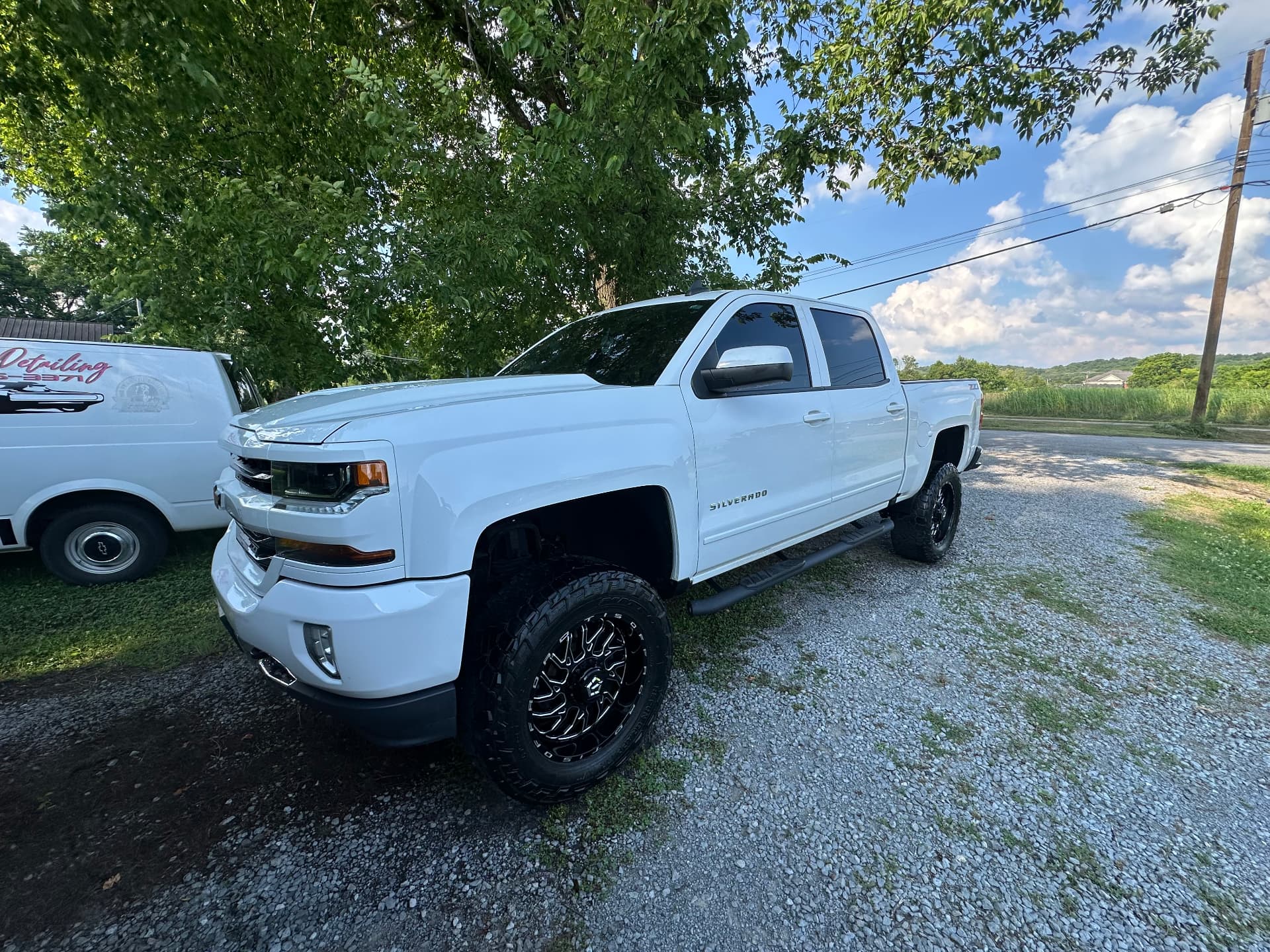 White lifted Chevrolet Silverado after a full exterior detail